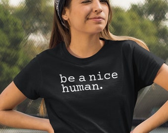 May include: A black t-shirt with white text that reads "be a nice human."