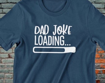 May include: A dark blue t-shirt with the text "Dad Joke Loading..." in white with a progress bar underneath.