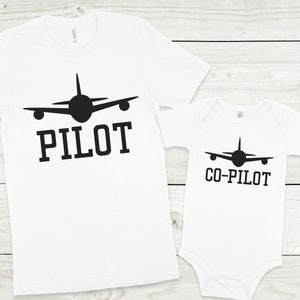 May include: White t-shirts with black airplane silhouettes and the words "PILOT" and "CO-PILOT" printed on them.