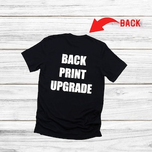 May include: Black t-shirt with white text on the back that reads "BACK PRINT UPGRADE".