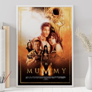 May include: Movie poster for the film "The Mummy" featuring a group of people in a desert setting with a large, golden, skeletal head in the background. The title "The Mummy" is written in large, bold letters at the bottom of the poster.