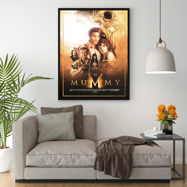 May include: A movie poster for the film "The Mummy" featuring a group of actors in front of a golden background. The title of the film is written in large, bold letters at the bottom of the poster.