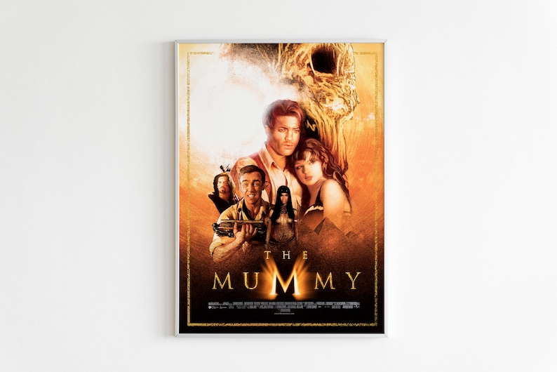 May include: Movie poster for "The Mummy" featuring a group of people in a desert setting. The poster has a gold and black color scheme with the title "The Mummy" in large, bold letters.