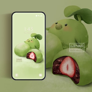 May include: A green phone screen with a digital clock displaying 1:43. The background is a green and white illustration of a mochi dessert with a strawberry filling. The text "SAPHINA BEGKISSE" is visible on the screen.