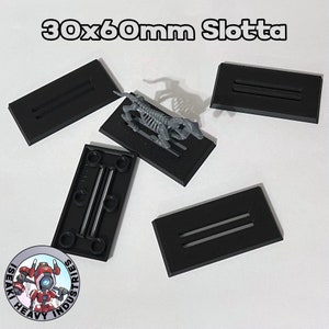 May include: Five black plastic bases with two slots each, designed for miniature figures. The bases are 30mm x 60mm and are ideal for wargaming or tabletop gaming.