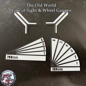 May include: White and black game gauges with the text "The Old World Line of Sight & Wheel Gauges". The set includes two Y-shaped pieces and two fan-shaped pieces marked with numbers and measurements of 200mm and 100mm.