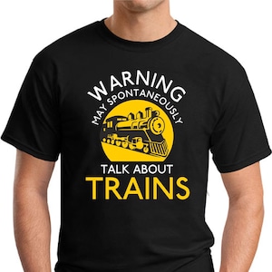 May include: Black t-shirt with a yellow circle and a cartoon train. The text "WARNING MAY SPONTANEOUSLY TALK ABOUT TRAINS" is printed on the shirt.