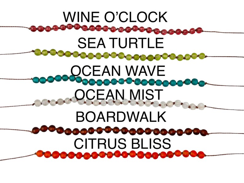 May include: A collection of beaded bracelets in various colors, including red, green, teal, white, brown, and orange. Each bracelet is labeled with a descriptive name such as "Wine O'Clock" and "Citrus Bliss".