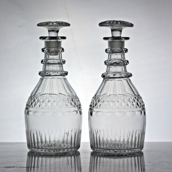 Pair of late Georgian, mouth-blown cut glass Prussian-shaped spirit decanters