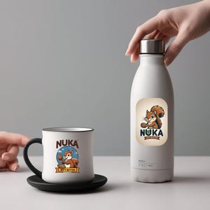 May include: A set of three ceramic mugs with a speckled, matte finish. The mugs are in shades of cream, light gray, and dark gray. Each mug has a simple, minimalist design, perfect for coffee or tea.