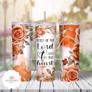 May include: Three stainless steel tumblers with a white background and a floral design in shades of orange and brown. The middle tumbler has the text "TRUST IN THE LORD WITH ALL YOUR HEART PROVERBS 3:5" printed on it.