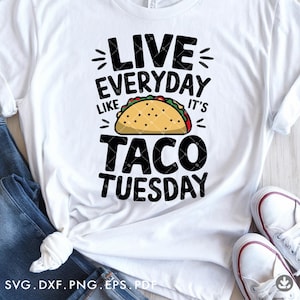 May include: White t-shirt with black text that reads "Live Everyday Like It's Taco Tuesday". A cartoon taco is pictured between the words "like" and "it's".