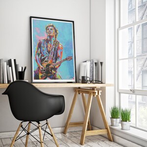 May include: A framed print of a colorful portrait of a musician playing a guitar. The background is a blue and purple gradient.