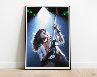 May include: A black and white photo of a musician playing an electric guitar on stage. The musician has long hair and is wearing a white shirt. The stage is lit with spotlights.
