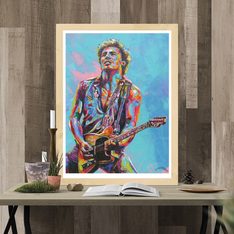 May include: A colorful painting of a man playing a guitar. The man is wearing a blue shirt and a black vest. The guitar is brown and has a white pickguard. The background is a blue and pink sky.