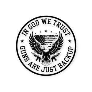 May include: A black and white circular sticker featuring an eagle with outstretched wings, an American flag, and text that reads "IN GOD WE TRUST" and "GUNS ARE JUST BACKUP". The design includes two rifles.