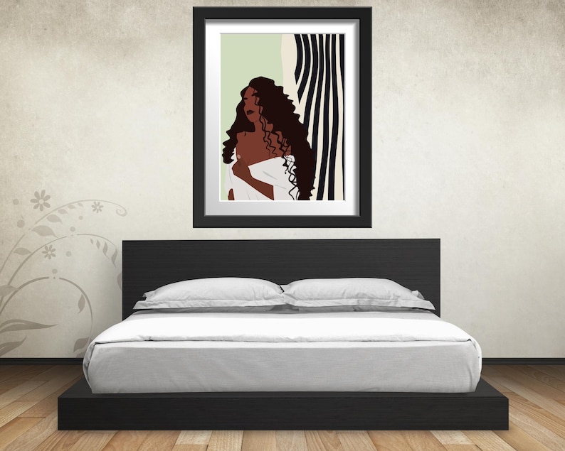 May include: A framed illustration of a woman with long, curly hair standing in front of a black and white striped background. The woman is wearing a white garment and has a neutral expression.
