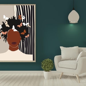 May include: A framed illustration of a person with brown skin and dark hair with butterflies in their hair. The background is a black and white striped pattern.