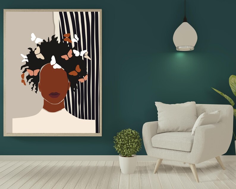 May include: A framed illustration of a person with brown skin and dark hair with butterflies in their hair. The background is a black and white striped pattern.