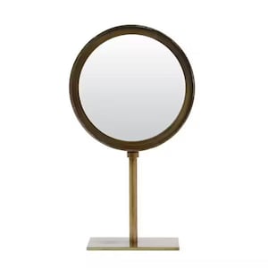Peut inclure: Un miroir de table rond de couleur or avec un pied. Le miroir a un design simple et moderne.