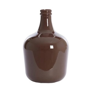 May include: A brown glass bottle with a rounded body and a narrow neck. The bottle has a glossy finish and reflects light. The bottle is empty and stands on a white background.