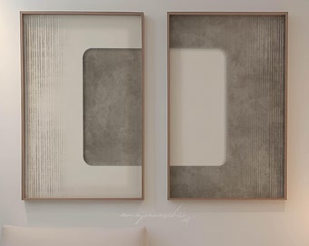 May include: Two framed abstract art prints with a white background and a gray geometric design. The prints are hanging on a white wall above a light beige couch.