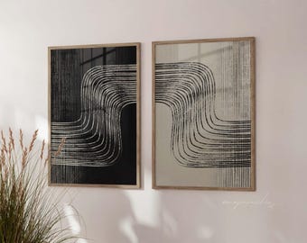 May include: Two framed abstract art prints. One print has a black background with white curved lines, the other a beige background with black curved lines. Both are in light brown wooden frames, creating a modern aesthetic.