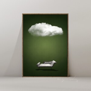 May include: A white cloud floats above a gray chaise lounge on a green background. The image is framed in a brown wood frame.