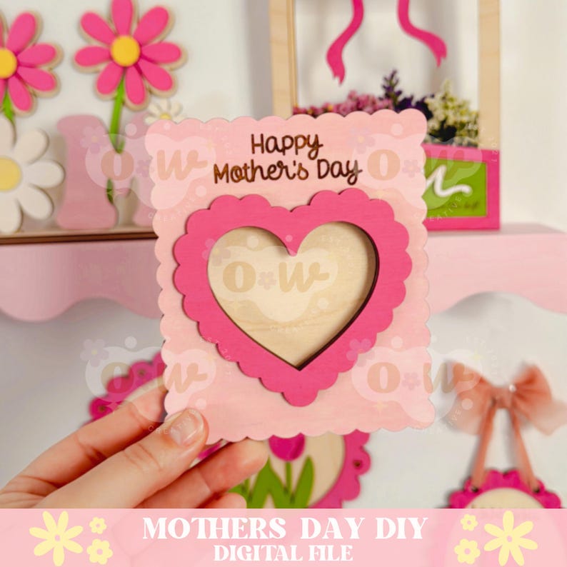 May include: Pink and white wooden card with a heart-shaped cutout and the text "Happy Mother's Day".