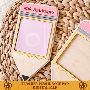 May include: Wooden pencil-shaped notepad with a pink eraser and a yellow pencil body. The notepad has a pink paper insert and the name "Mrs. Aguiano" is engraved on the eraser. The bottom of the image reads "Teacher Pencil Note Pad Digital File."