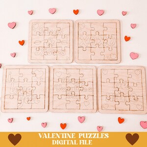 May include: Four wooden Valentine's Day puzzles with different designs. The puzzles are made of light wood and have a white outline. The designs include "Hugs & Kisses", "XOXO", "I Love You", and "Happy Valentine's Day".