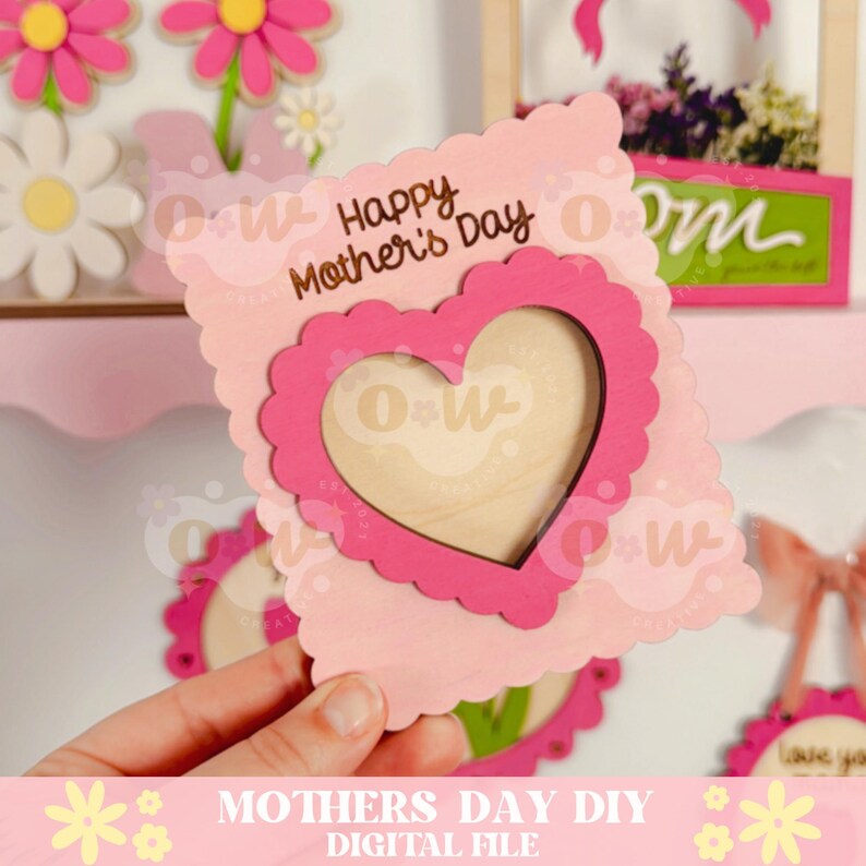 May include: Pink and white wooden card with a heart-shaped cutout. The card says "Happy Mother's Day" and has a space for a photo.