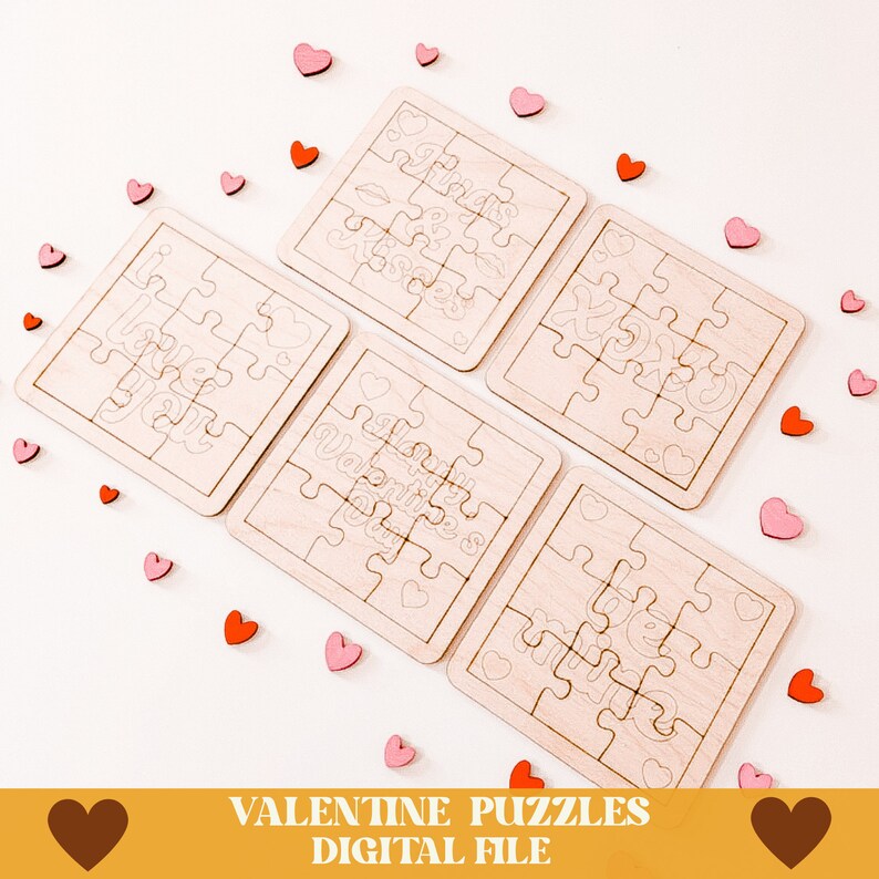 May include: Five unfinished wooden jigsaw puzzles with Valentine's Day themes. The puzzles are arranged in a circle on a white background with pink and red hearts scattered around them. The puzzles feature the phrases "I love you", "Happy Valentine's Day", "Hugs & Kisses", "XOXO", and "Love you more".