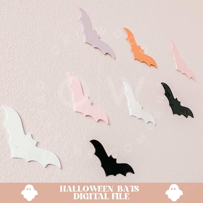 May include: A set of eight Halloween bat cutouts in various colours, including black, white, pink, orange, and purple. The bats are arranged on a light pink wall. The text "HALLOWEEN BATS DIGITAL FILE" is at the bottom of the image.