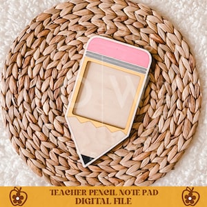 May include: A wooden pencil-shaped notepad with a pink eraser, gray ferrule, and gold accents. The notepad is on a woven, circular mat. The text "TEACHER PENCIL NOTE PAD DIGITAL FILE" is at the bottom.