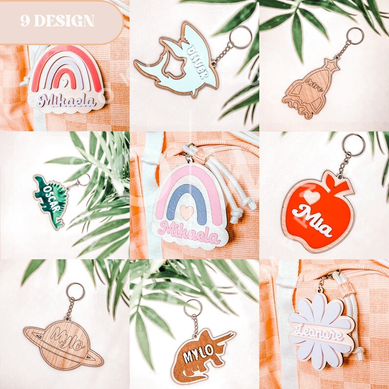 May include: Nine different designs of personalized wooden keychains. The designs include a rainbow, a dinosaur, a shark, a rocket, an apple, a flower, a planet, and a unicorn. Each keychain has a different name on it.