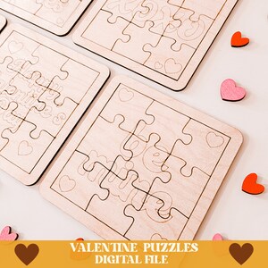 May include: Four unfinished wooden jigsaw puzzles with Valentine's Day themes. The puzzles feature the words "Happy Valentine's Day", "We", and "Love You".