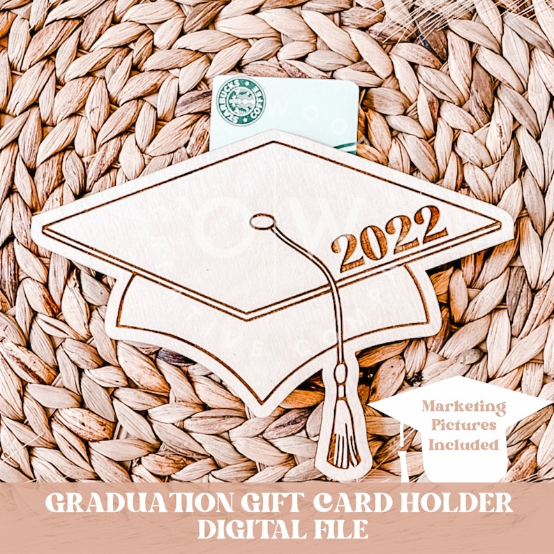 May include: A wooden graduation cap gift card holder with the year 2022 engraved on it. The holder is designed to hold a gift card or cash. The holder is sitting on a woven mat.