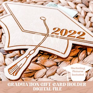 May include: A wooden graduation cap gift card holder with the year 2022 engraved on it. The holder is designed to hold a gift card or cash for a graduate. The image includes the text "Marketing Pictures Included".