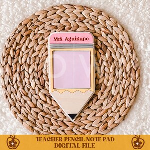 May include: A teacher-themed pencil-shaped notepad with a pink eraser and a pink notepad. The notepad has the text "Mrs. Aguiano" on the eraser. The notepad is on a woven, circular placemat. The bottom of the image has the text "TEACHER PENCIL NOTE PAD DIGITAL FILE".