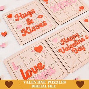 May include: Four wooden Valentine's Day jigsaw puzzles with pink and red lettering. The puzzles feature the phrases "Hugs & Kisses", "I Love You", "Happy Valentine's Day", and "XOX".