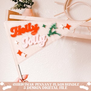 May include: A wooden pennant flag with the words "Holly Jolly" in red and pink letters, a green reindeer, and red and white stars. The flag is part of a Christmas pennant flag bundle.