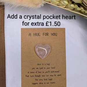 May include: A pink crystal heart on a brown card with the text "A HUG FOR YOU" and a poem about hugs. The image also includes the text "Add a crystal pocket heart for extra &pound;1.50".