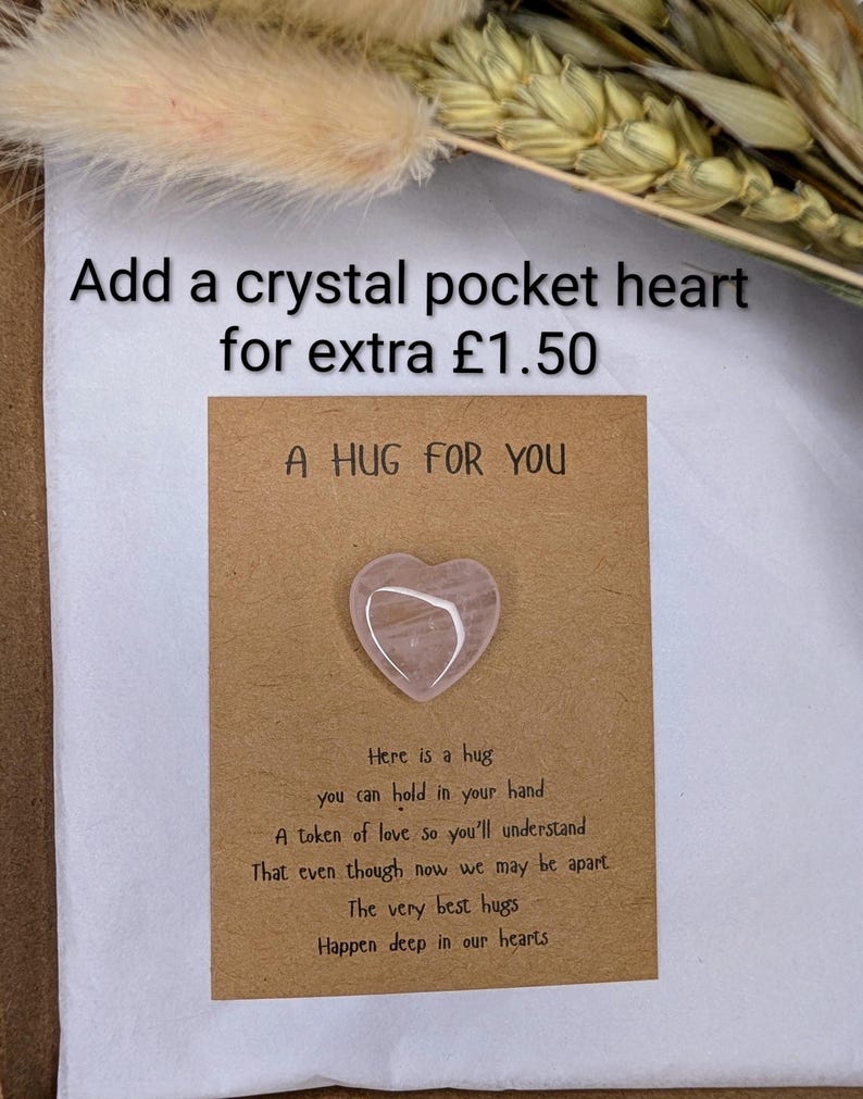 May include: A pink crystal heart on a brown card with the text "A HUG FOR YOU" and a poem about hugs. The image also includes the text "Add a crystal pocket heart for extra &pound;1.50".