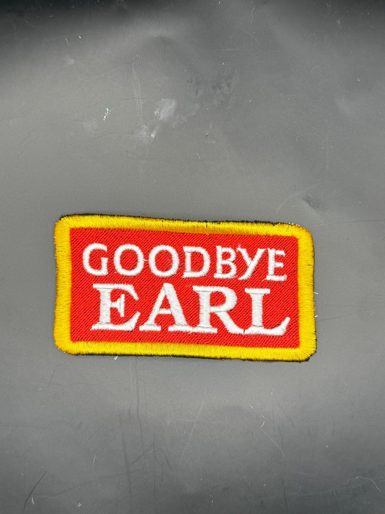 May include: A red and yellow embroidered patch with the text "Goodbye Earl" in white lettering.