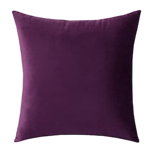May include: A square, solid-colored decorative pillow in a deep purple hue. The pillow has a soft, velvety texture and a simple, minimalist design, perfect for adding a touch of color and comfort to any living space.