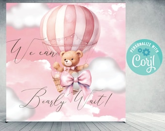 May include: A pink backdrop with a watercolor illustration of a teddy bear in a hot air balloon. The balloon is pink and white striped. The text "We can bearly wait!" is written in cursive. A teal circle with the text "Personalize with Corjl" is in the corner.