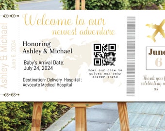 May include: A white and gold baby shower invitation in the shape of a boarding pass. The invitation says "Welcome to our newest adventure" and includes the names Ashley & Michael, the baby's arrival date of July 24, 2024, and the destination of Advocate Medical Hospital. The invitation also includes a QR code and the text "Scan our code to upload any baby shower photo".