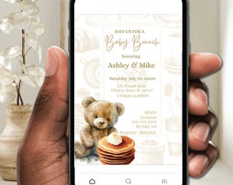 May include: A digital invitation for a baby brunch, featuring a cartoon teddy bear holding a stack of pancakes. The invitation is for Ashley & Mike and includes the date, time, and location of the event. RSVP information and a registry link are also included.