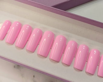 May include: A set of ten pink press-on nails in a pink box with the text "L.M.D. Nail Boutique".